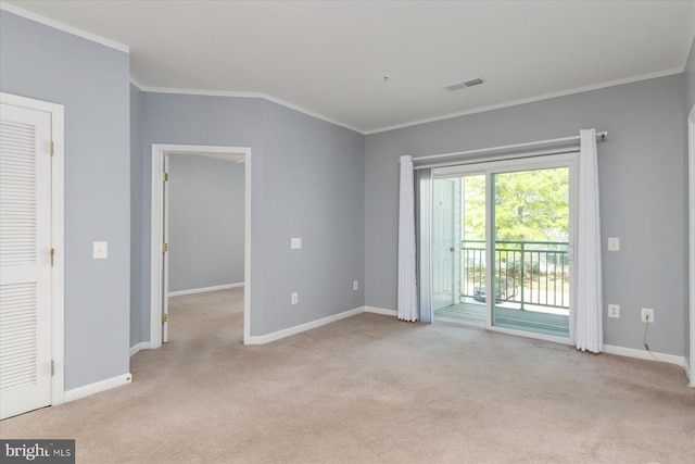 carpeted empty room featuring crown molding, baseboards, and visible vents