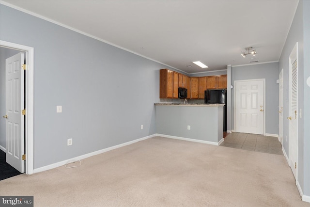 unfurnished living room with baseboards, ornamental molding, and light colored carpet