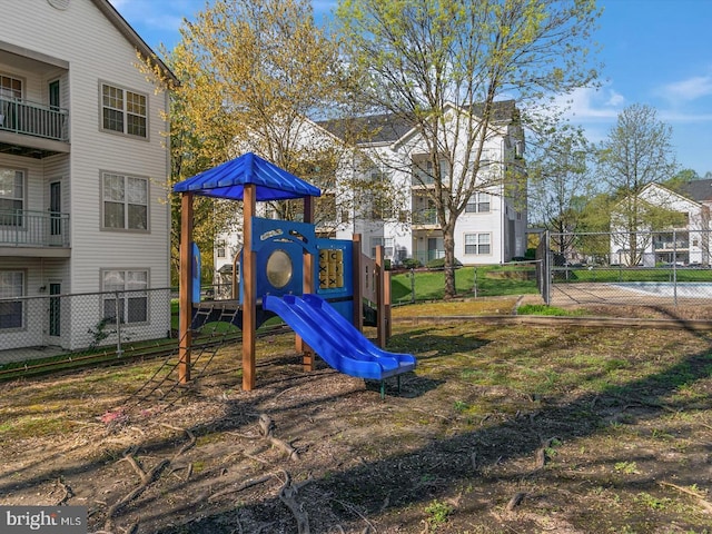 view of jungle gym featuring fence