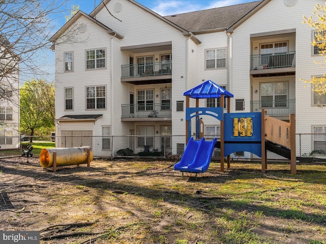 back of house with fence and playground community