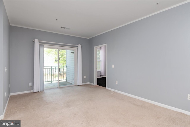 spare room with baseboards, light carpet, and visible vents
