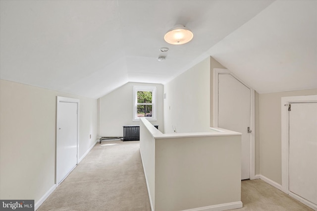 additional living space featuring light colored carpet, baseboards, and lofted ceiling