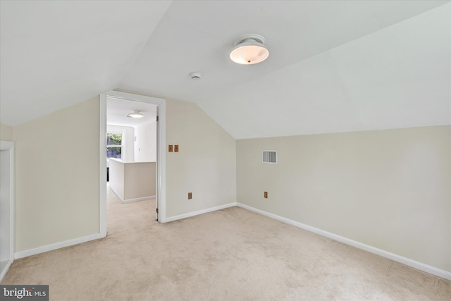 bonus room with light colored carpet, baseboards, and visible vents