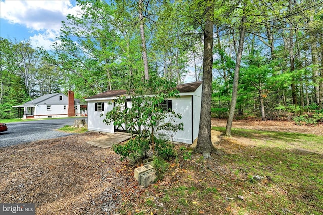view of front of home featuring a storage shed and an outdoor structure