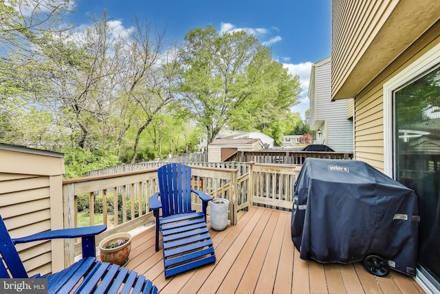 wooden deck with fence and grilling area