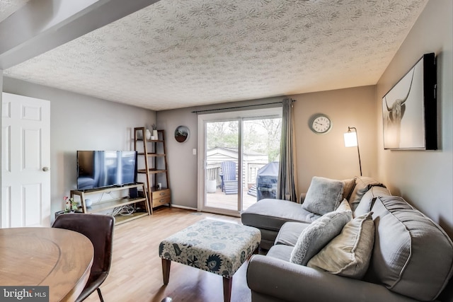 living area featuring a textured ceiling and wood finished floors