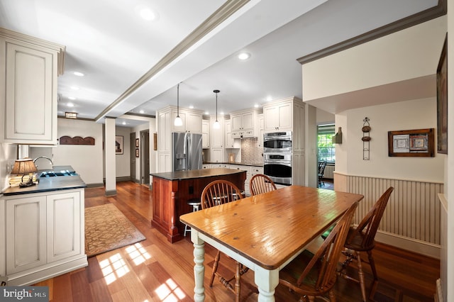dining area featuring a wainscoted wall, recessed lighting, and light wood-style flooring
