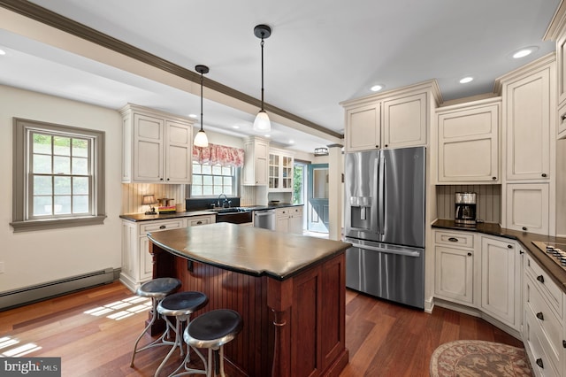 kitchen with dark countertops, appliances with stainless steel finishes, and dark wood-type flooring