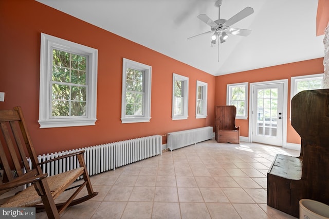 unfurnished room featuring radiator, ceiling fan, baseboards, and lofted ceiling