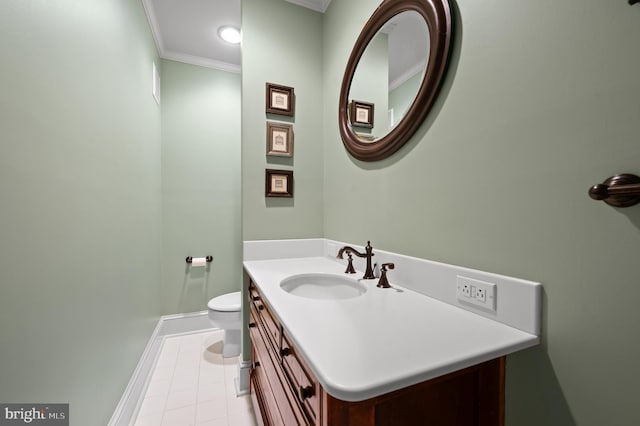 half bathroom featuring crown molding, tile patterned flooring, baseboards, vanity, and toilet