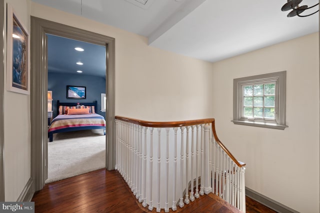 corridor featuring recessed lighting, baseboards, an upstairs landing, and hardwood / wood-style flooring
