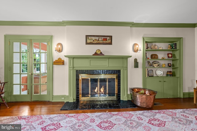 living room featuring a high end fireplace and wood finished floors