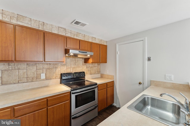4411 Pembrook Village Dr Unit 101, Alexandria, VA 22309 - kitchen featuring light countertops, under cabinet range hood, stainless steel electric stove, a sink, and backsplash