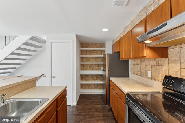 4411 Pembrook Village Dr Unit 101, Alexandria, VA 22309 - kitchen with brown cabinetry, visible vents, black electric range, a sink, and under cabinet range hood
