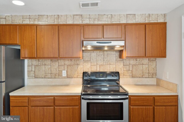 4411 Pembrook Village Dr Unit 101, Alexandria, VA 22309 - kitchen featuring visible vents, light countertops, appliances with stainless steel finishes, and extractor fan