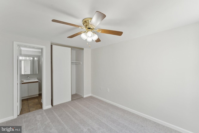 4411 Pembrook Village Dr Unit 101, Alexandria, VA 22309 - unfurnished bedroom with light colored carpet, a sink, baseboards, ensuite bathroom, and a closet