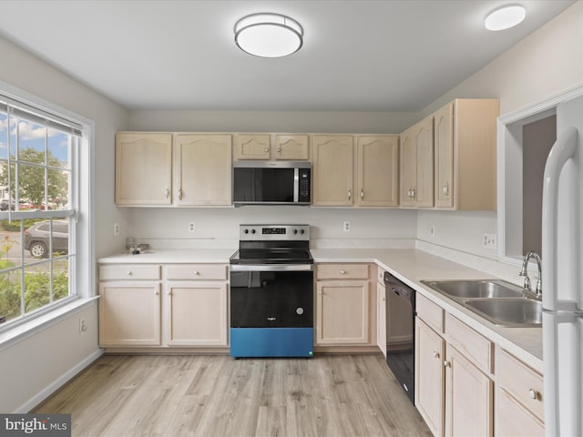 109 Donelson Loop, Stafford, VA 22554 - kitchen with stainless steel appliances, light brown cabinets, a sink, and light wood-style floors
