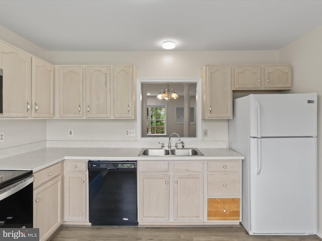 109 Donelson Loop, Stafford, VA 22554 - kitchen with black dishwasher, freestanding refrigerator, a sink, light brown cabinetry, and electric stove