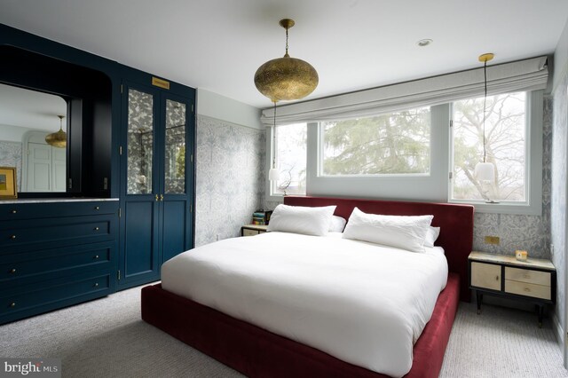 carpeted bedroom featuring wallpapered walls