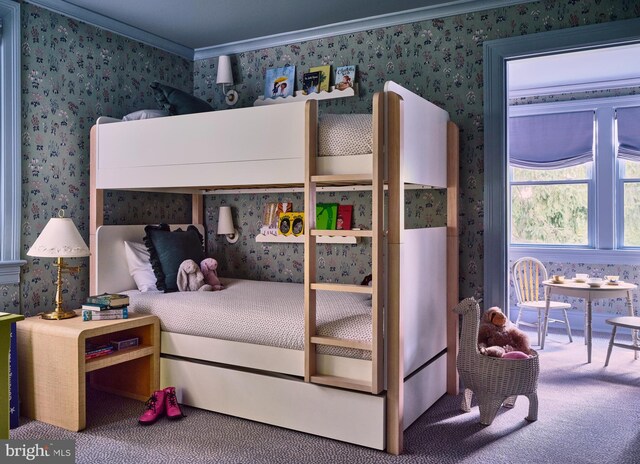 carpeted bedroom with ornamental molding and wallpapered walls
