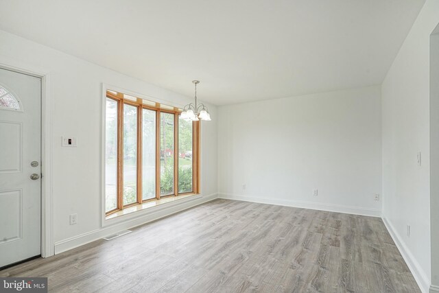 505 University Blvd, Wenonah, NJ 08090 - unfurnished dining area with a chandelier, light wood-type flooring, and baseboards