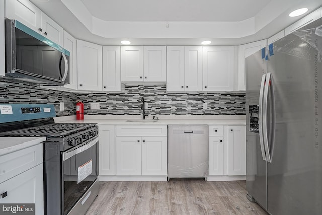 505 University Blvd, Wenonah, NJ 08090 - kitchen featuring appliances with stainless steel finishes, a sink, light countertops, and white cabinets
