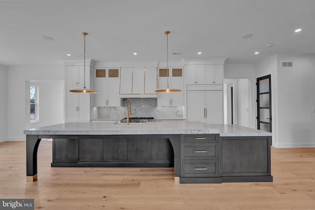 457 Brownsburg Rd W, Unit W, Newtown, PA 18940 - kitchen with white cabinetry, baseboards, visible vents, and paneled fridge