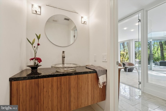 bathroom with vanity, visible vents, and marble finish floor