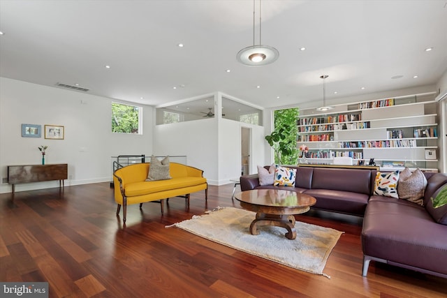 living area featuring plenty of natural light, wood finished floors, and visible vents
