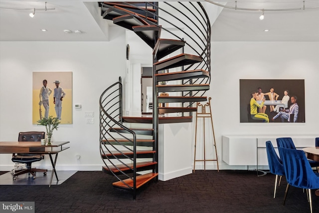 staircase with carpet floors and baseboards