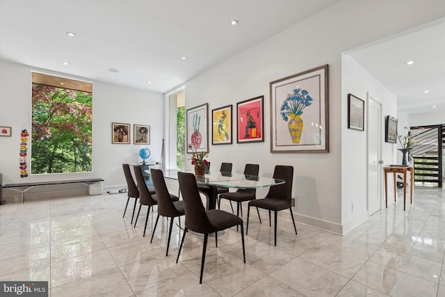 dining space featuring baseboards, recessed lighting, and marble finish floor