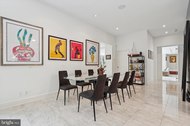 dining room with recessed lighting, baseboards, and marble finish floor