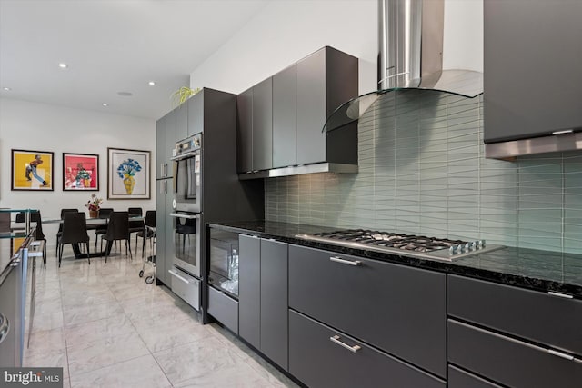 kitchen featuring decorative backsplash, marble finish floor, recessed lighting, dark stone countertops, and appliances with stainless steel finishes