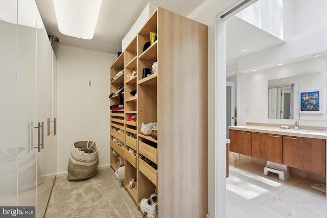 walk in closet featuring light tile patterned flooring