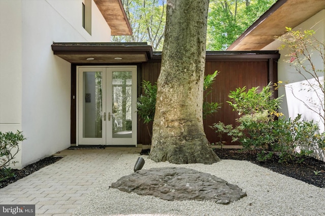entrance to property with french doors and stucco siding