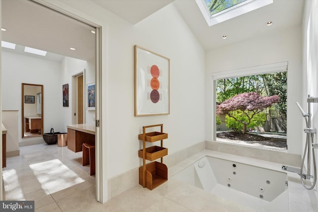 bathroom featuring vanity, recessed lighting, a whirlpool tub, and a skylight