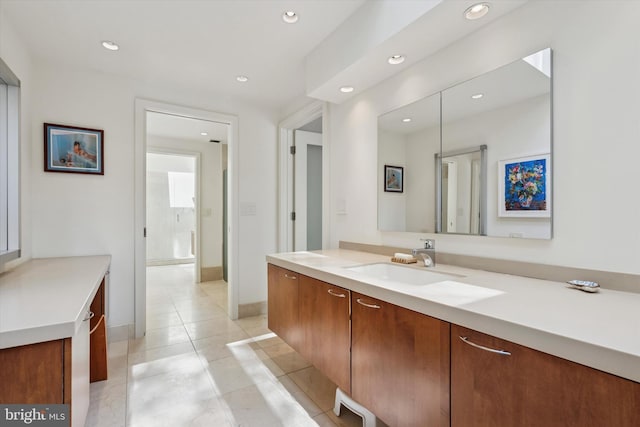 bathroom featuring vanity, recessed lighting, baseboards, and tile patterned flooring