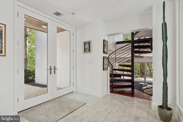 foyer featuring visible vents, marble finish floor, stairs, baseboards, and french doors