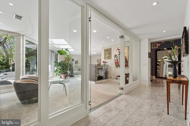 interior space featuring visible vents, recessed lighting, and marble finish floor