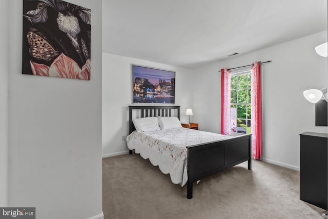 bedroom featuring baseboards and carpet