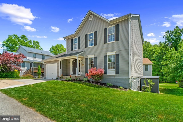 view of front of house featuring a garage, concrete driveway, and a front yard