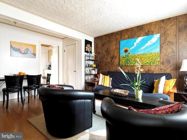4627 Central Ave NE, Washington, DC 20019 - living area featuring wooden walls and wood finished floors