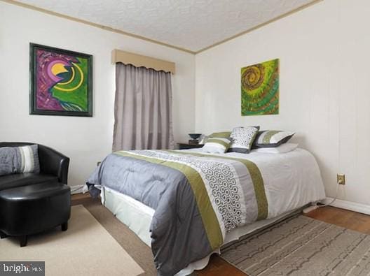 4627 Central Ave NE, Washington, DC 20019 - bedroom featuring baseboards, a textured ceiling, and wood finished floors