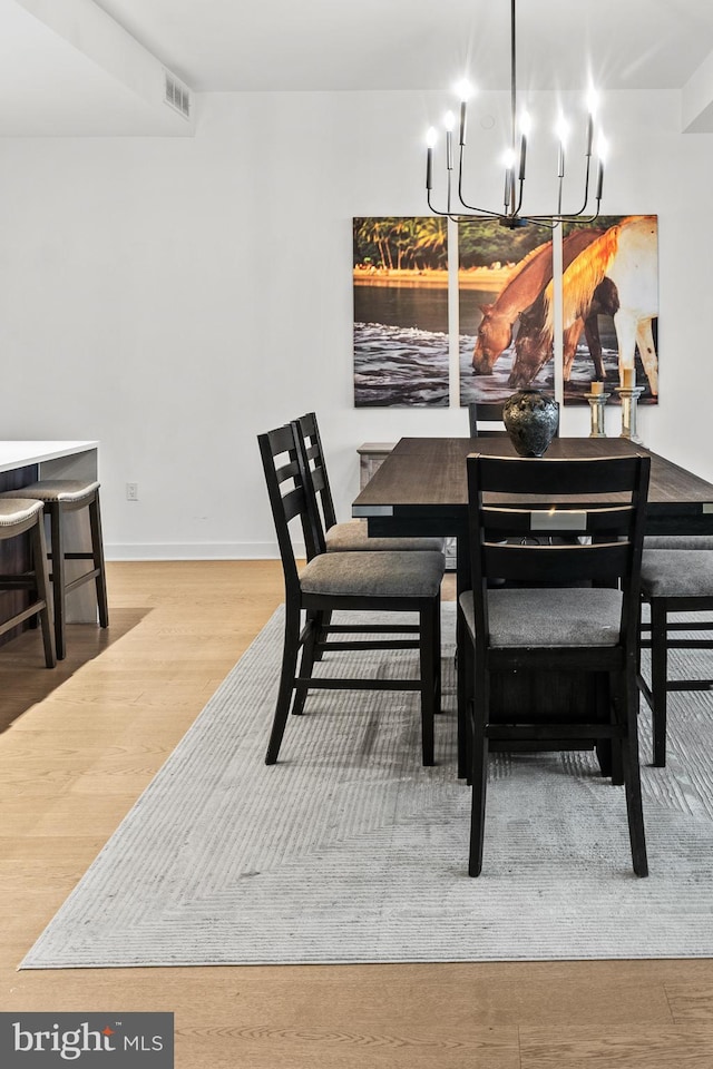 1650 Silver Hill Dr Unit 1706, Mclean, VA 22102 - dining space featuring a chandelier, baseboards, visible vents, and wood finished floors