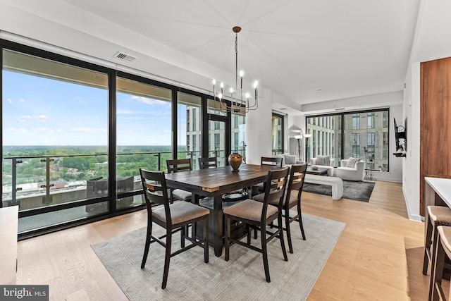 1650 Silver Hill Dr Unit 1706, Mclean, VA 22102 - dining space featuring a healthy amount of sunlight, light wood-style flooring, a chandelier, and visible vents