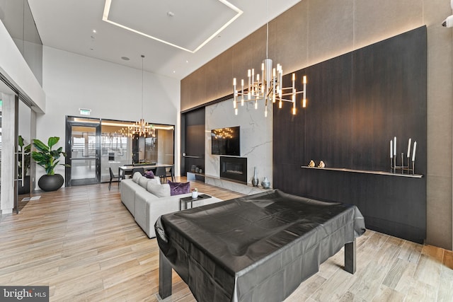 1650 Silver Hill Dr Unit 1706, Mclean, VA 22102 - playroom featuring pool table, a notable chandelier, wood finished floors, and a towering ceiling