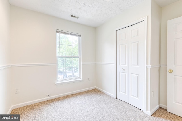 7 Silver Birch Ct, Owings Mills, MD 21117 - unfurnished bedroom featuring carpet floors, a closet, and a textured ceiling