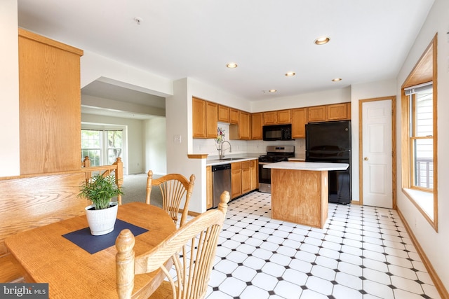 7 Silver Birch Ct, Owings Mills, MD 21117 - kitchen featuring black appliances, light floors, light countertops, a center island, and recessed lighting