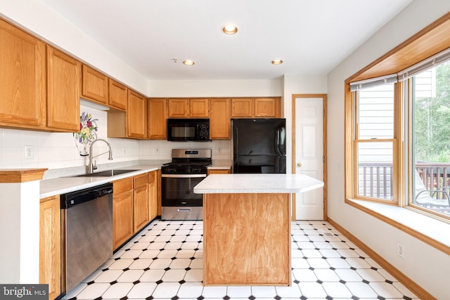 7 Silver Birch Ct, Owings Mills, MD 21117 - kitchen featuring black appliances, light flooring, light countertops, a center island, and tasteful backsplash