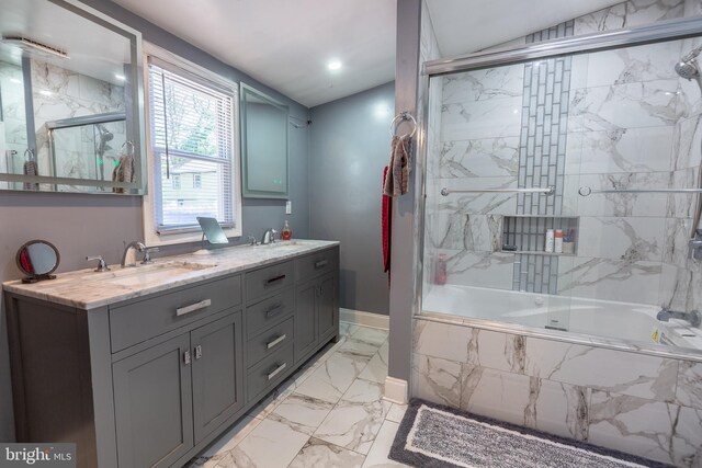 full bathroom featuring a sink, double vanity, marble finish floor, tiled shower / bath, and vaulted ceiling